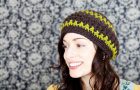 stock photo of a young woman wearing a handmade beret style hat; smiling